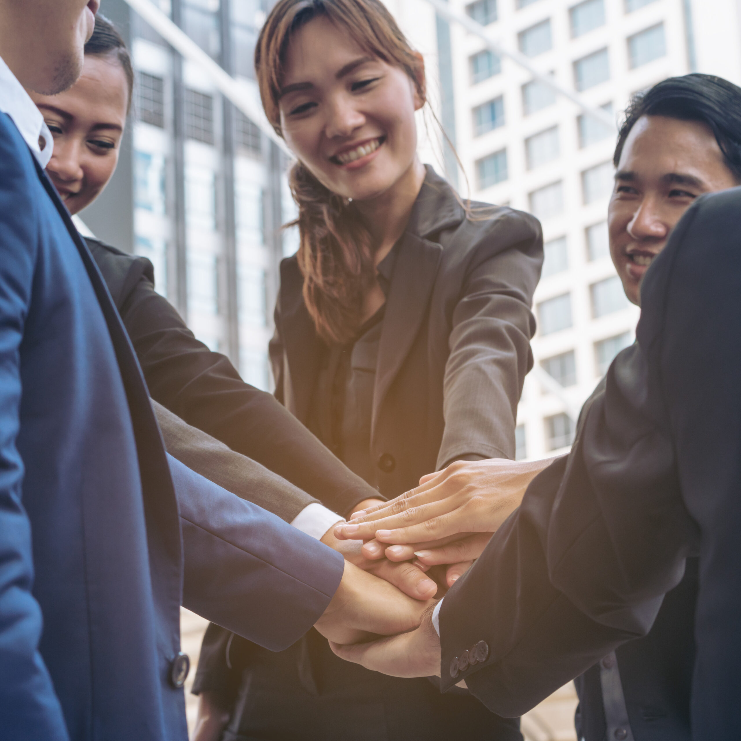 Business people joining hands showing teamwork